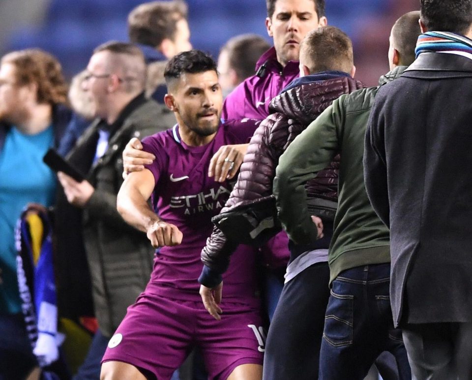  Sergiop Aguero is confronted by pitch invader at DW Stadium