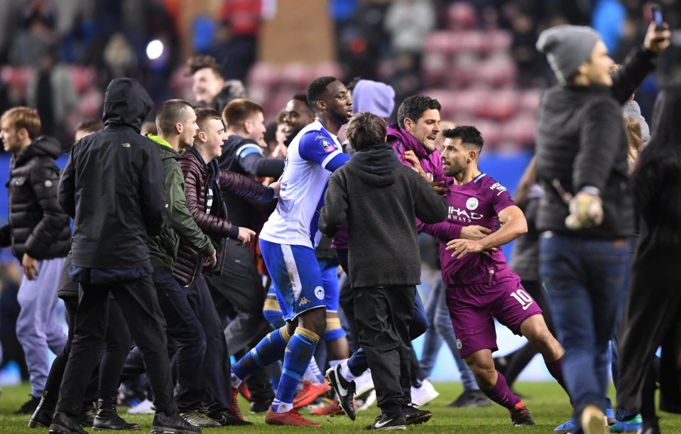  Aguero tries to force his way towards the supporter after losing his temper