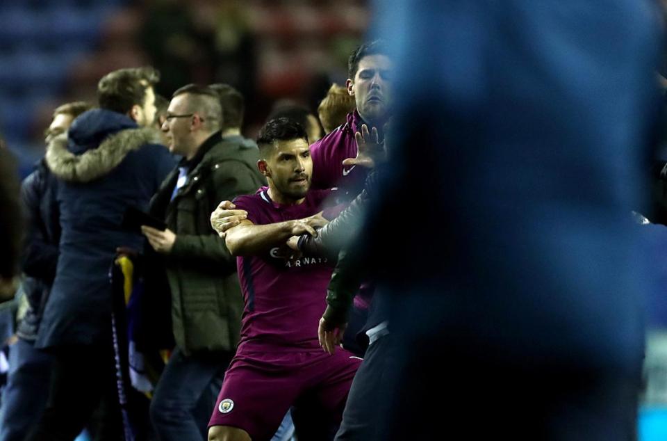  Sergio Aguero got in a row with a Wigan fan as jubilant supporters ran on pitch