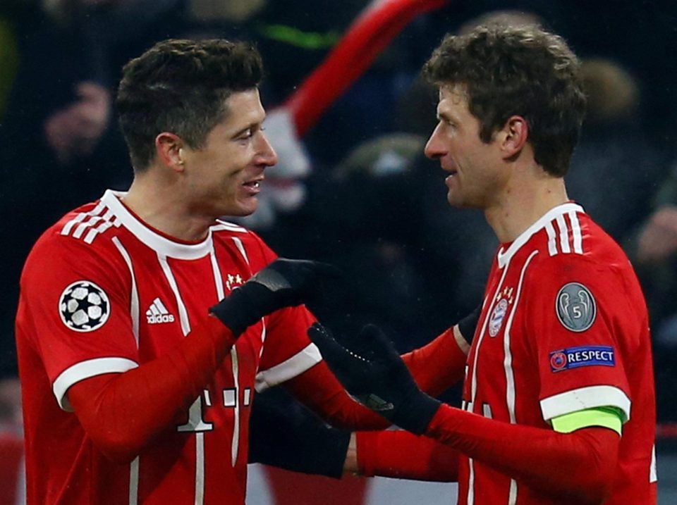  Robert Lewandowski celebrates the first strike in his late double with fellow two-goal hero Thomas Muller