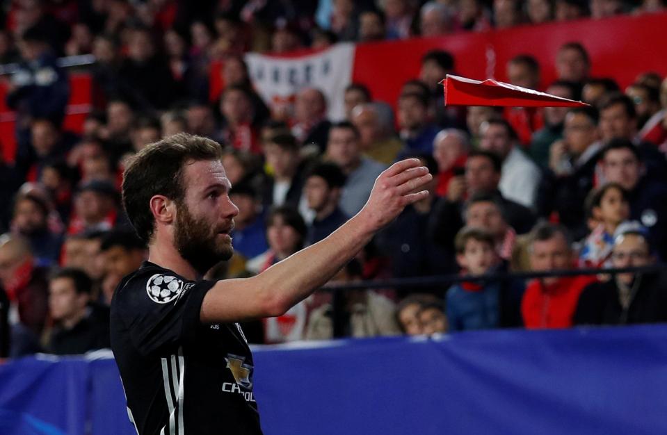  Juan Mata throws a paper airplane off the pitch in Man Utd's draw with Sevilla