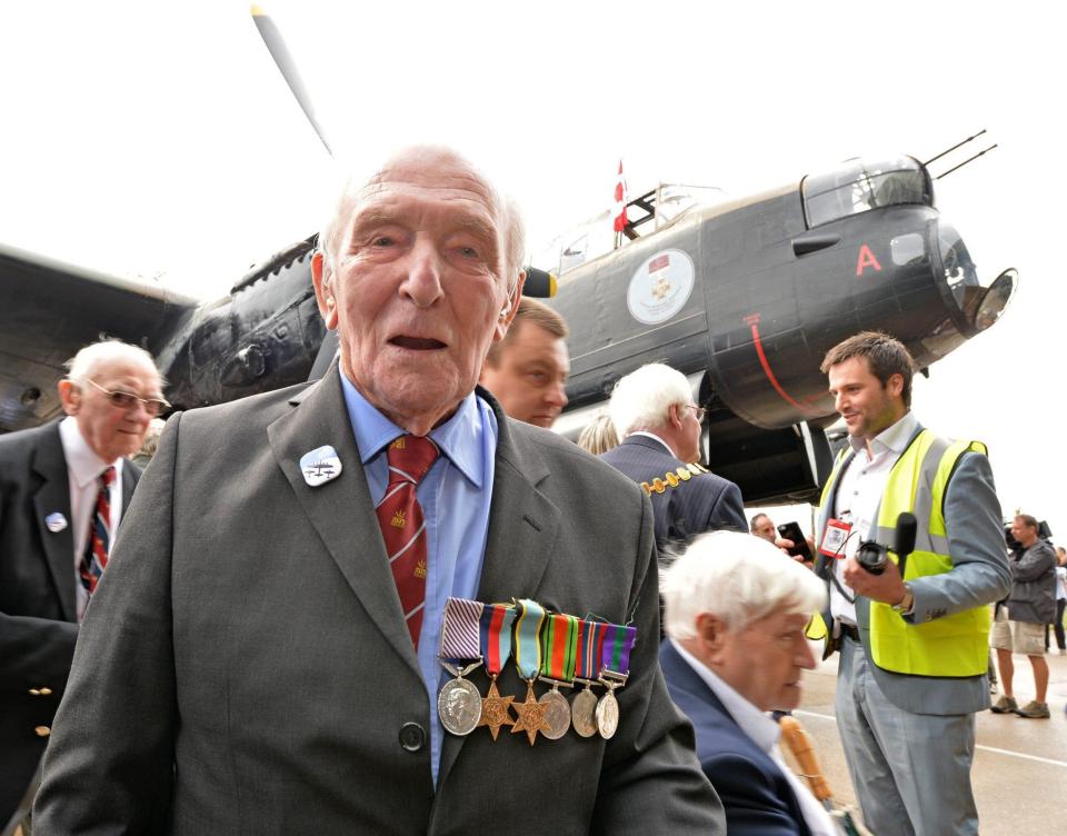  George 'Johnny' Johnson in front of a Lancaster bomber, like the ones used in the raid