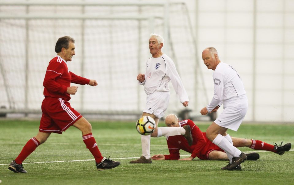  John Junior gets stuck in against Wales veterans at St George's Park