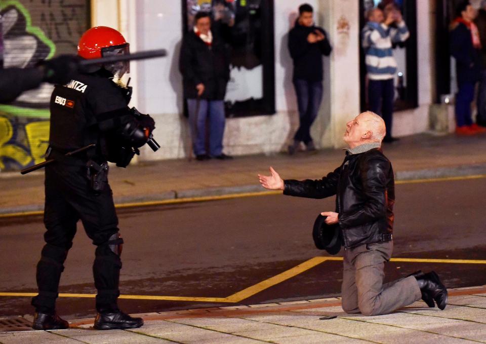  A man remonstrates with a police officer