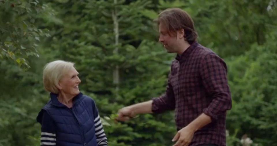  Niklas kneels in front of Mary to build a fire