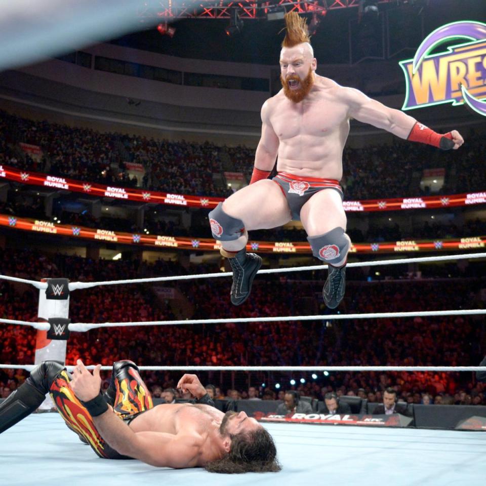  Sheamus drops a knee on Seth Rollins