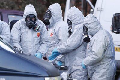  Forensic officers wear gas masks as they scour the scene of the suspected assassination bid on a former Russian spy and his daughter