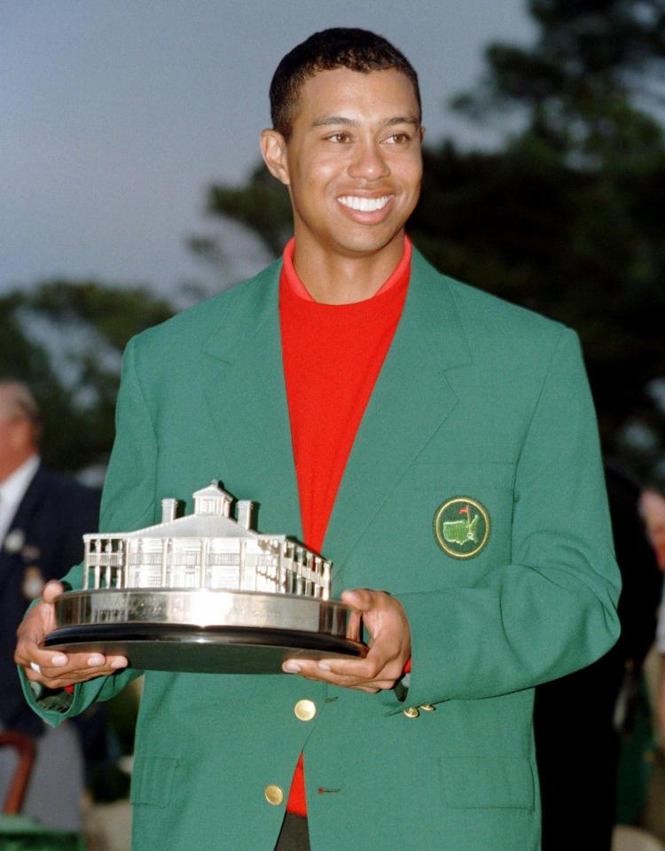  Woods poses with the Masters trophy in 1997