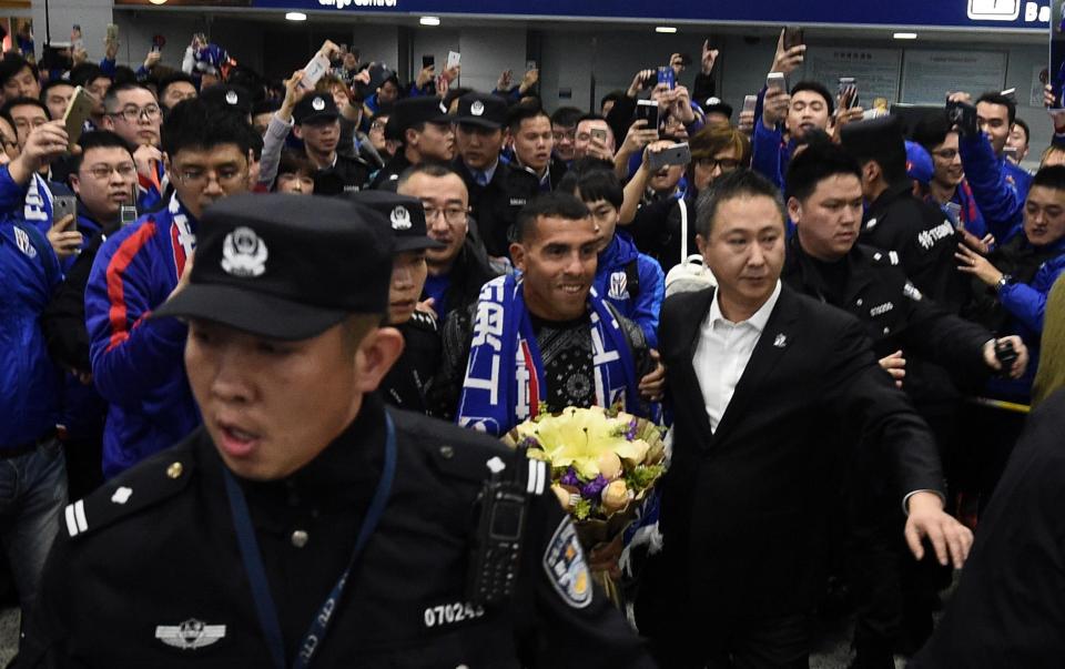  Carlos Tevez needed security to help him through the crowds on his arrival