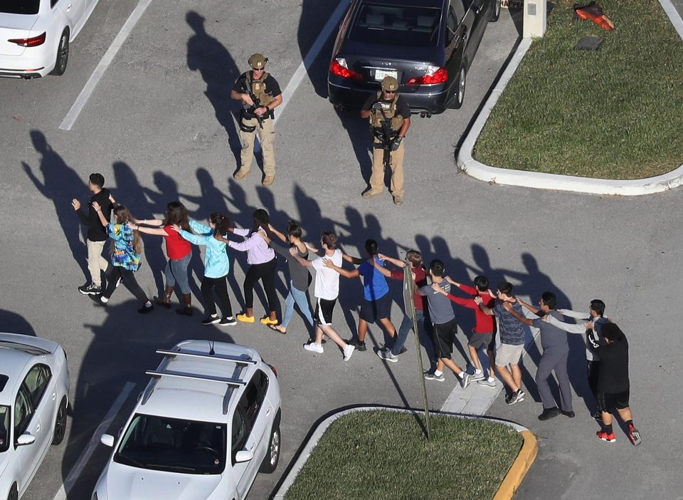  Students being led out of Marjory Stoneman Douglas High School in Parkland, Florida, after a deathly shooting