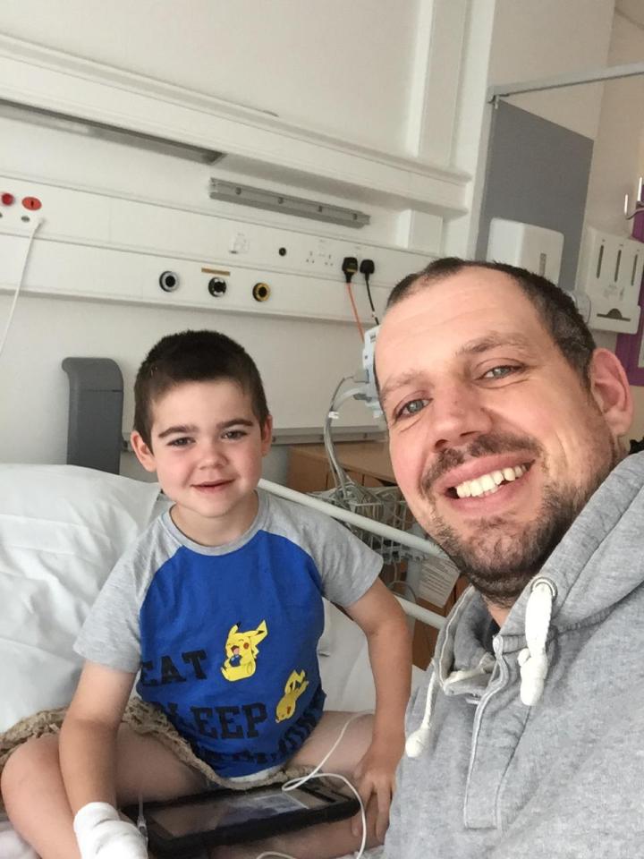  Alfie, seen here during a previous hospital stay with dad Drew, suffers up to 30 seizures a day