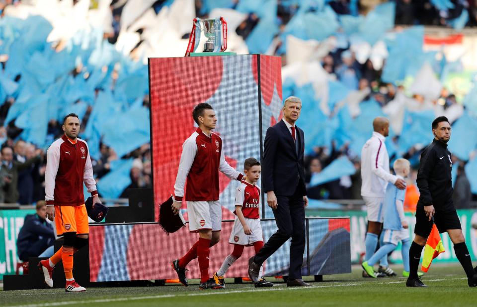  Arsene Wenger and Laurent Koscielny walk out at Wembley for Carabao Cup final