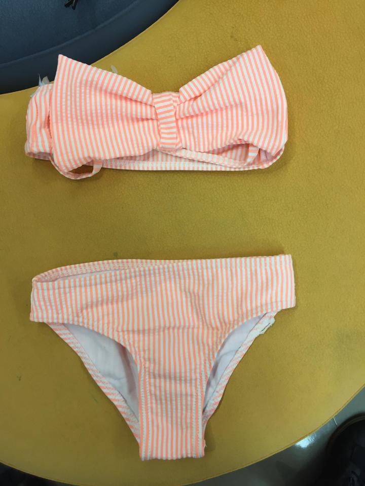  The peach version is strapless and has a bow on the front