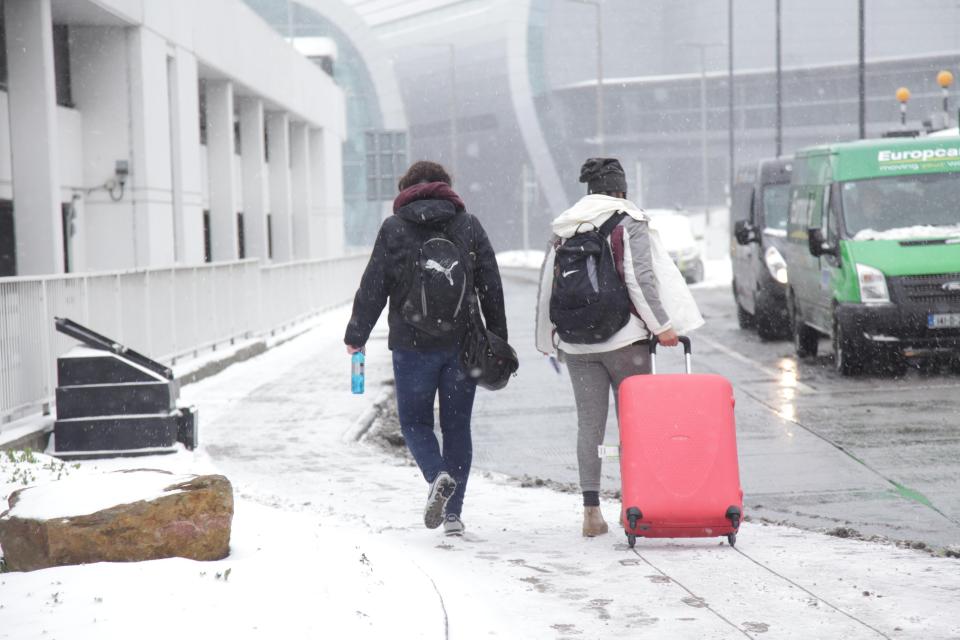  Passengers battle through snow at Dublin Airport - which is currently closed