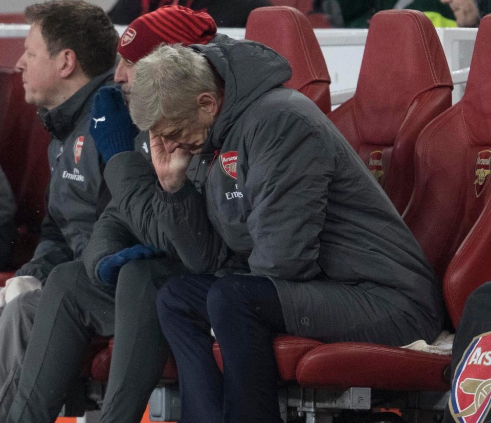  Arsene Wenger looks dejected after watching his side struggle in the first half