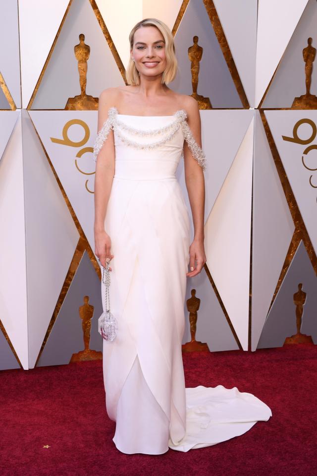  Margot Robbie wowed in a chic ivory floor-skimming Chanel gown with glitter detailing across the shoulders