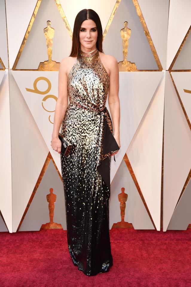  Sandra Bullock wowed in a glittering halter neck black and gold gown