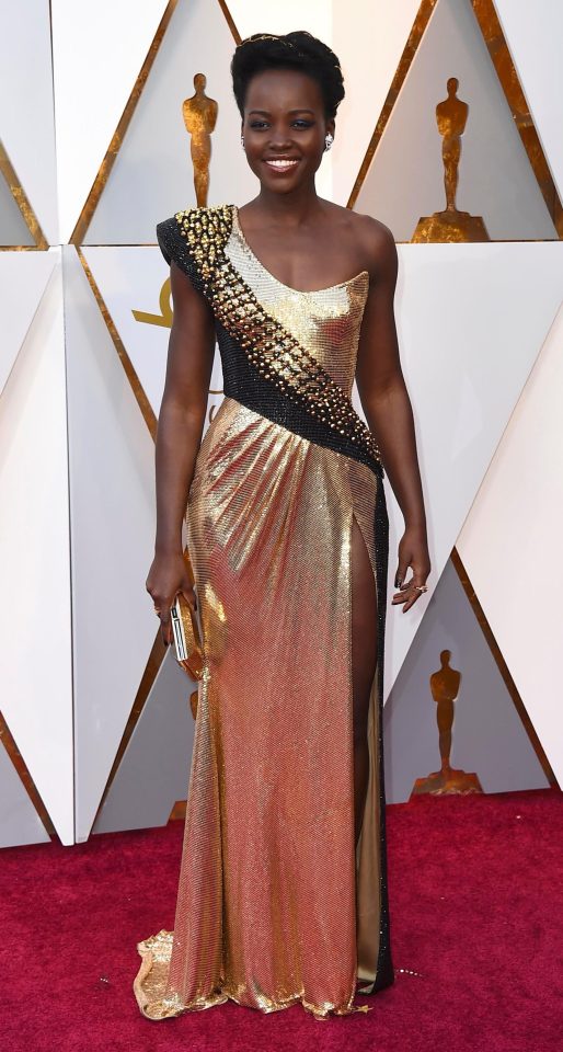  Lupita Nyong'o glittered in one-shoulder gold dress complete with a daring thigh-high split