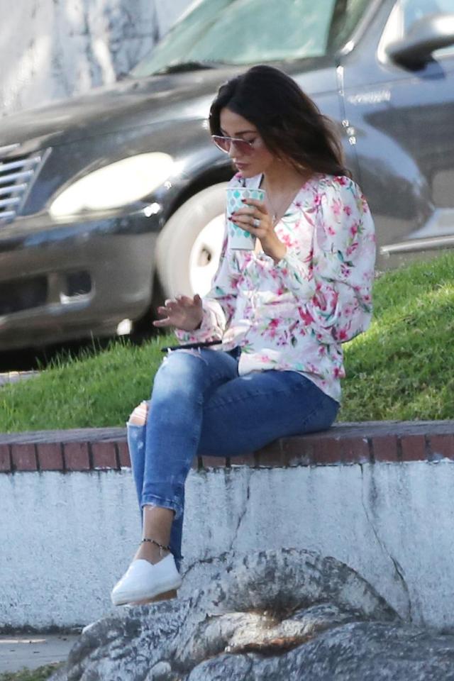  She checked her phone as she sipped on her drink