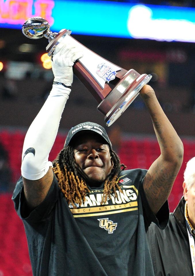  Shaquem lifts the trophy at the Peach Bowl in January during his final collegiate game with University of Central Florida