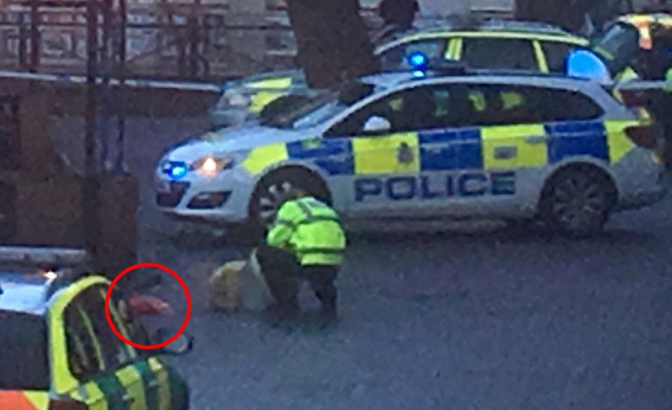  Police officer crouches down next to the shopping centre bench where Sergei Skripal, 66, and his daughter Yulia, 33, were found slumped unconscious