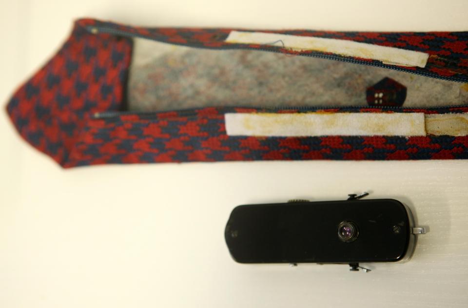  A KGB Totschka camera displayed next to the tie it was hidden in