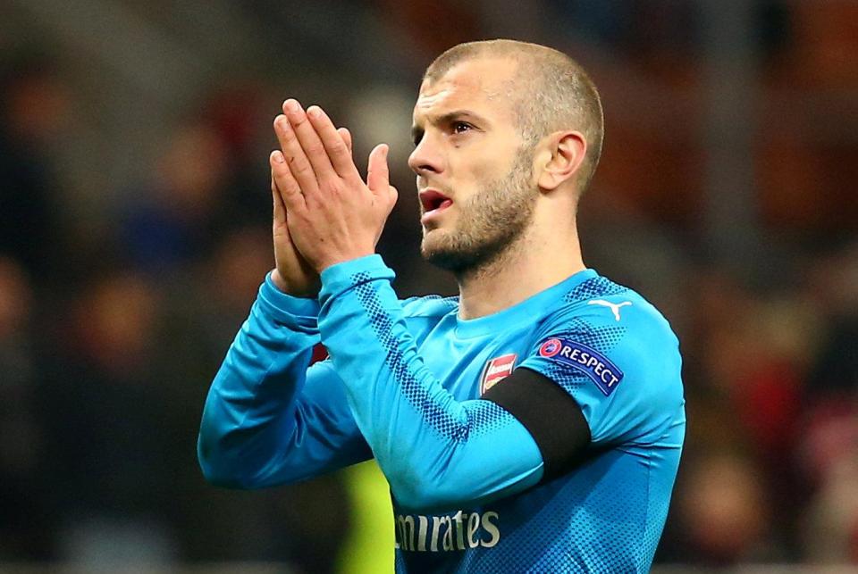  Jack Wilshere applauds the travelling Arsenal fans after the 2-0 win over AC Milan