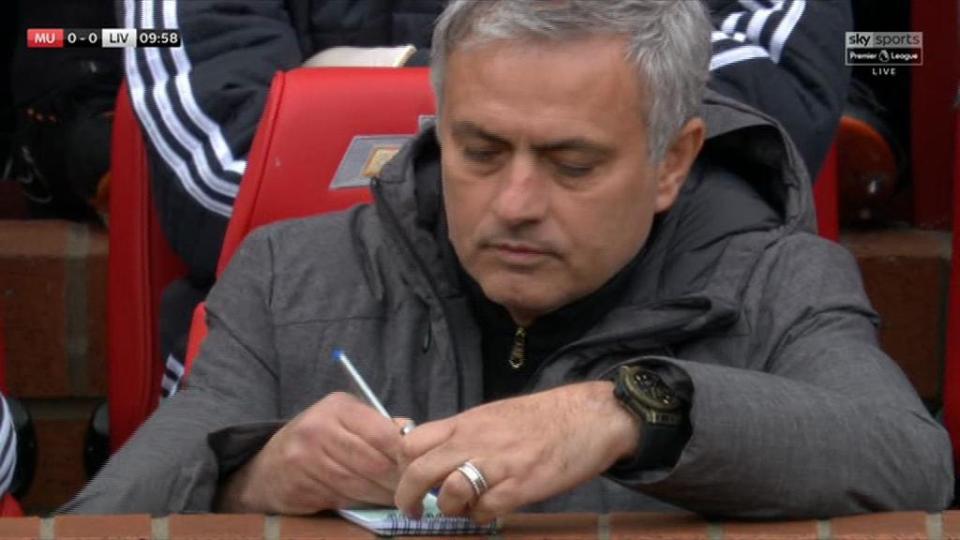  Jose Mourinho scribbles in his notebook as he takes in United's clash with Liverpool