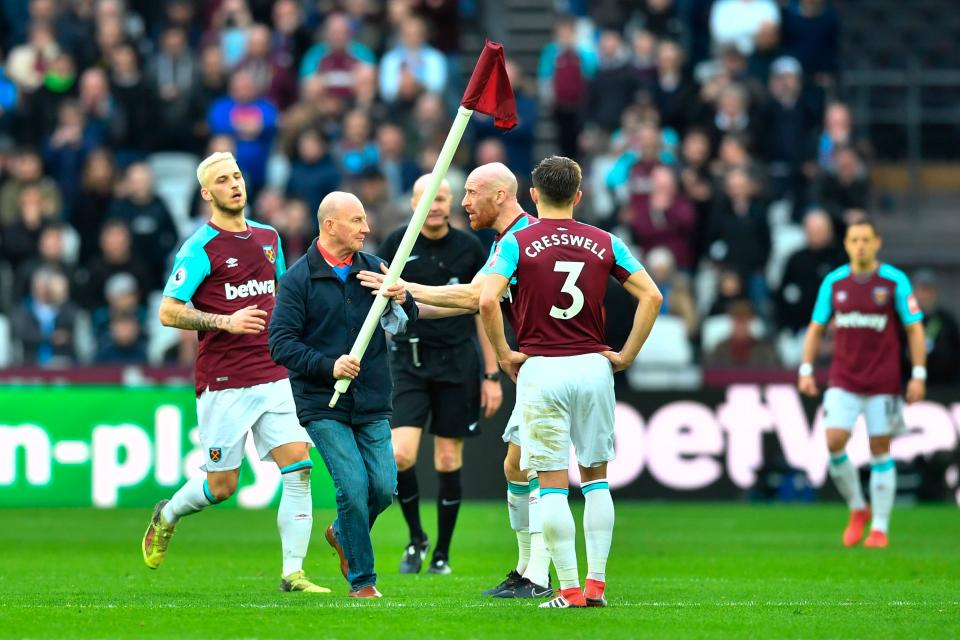  A West Ham fan takes a flag to the centre spot during a 3-0 defeat to Burnley