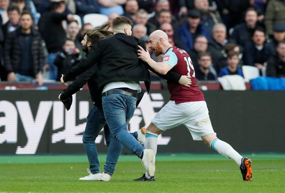  James Collins tries to get a fan off the pitch in the defeat to Burnley on March 10