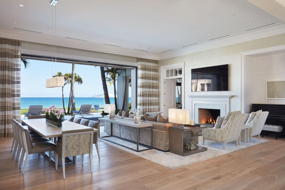 Gorgeous living room has plenty of space to sit down with a TV and fireplace in-built in the wall