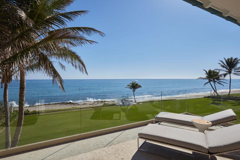  A balcony attached to the mansion overlooks the blue skies and ocean