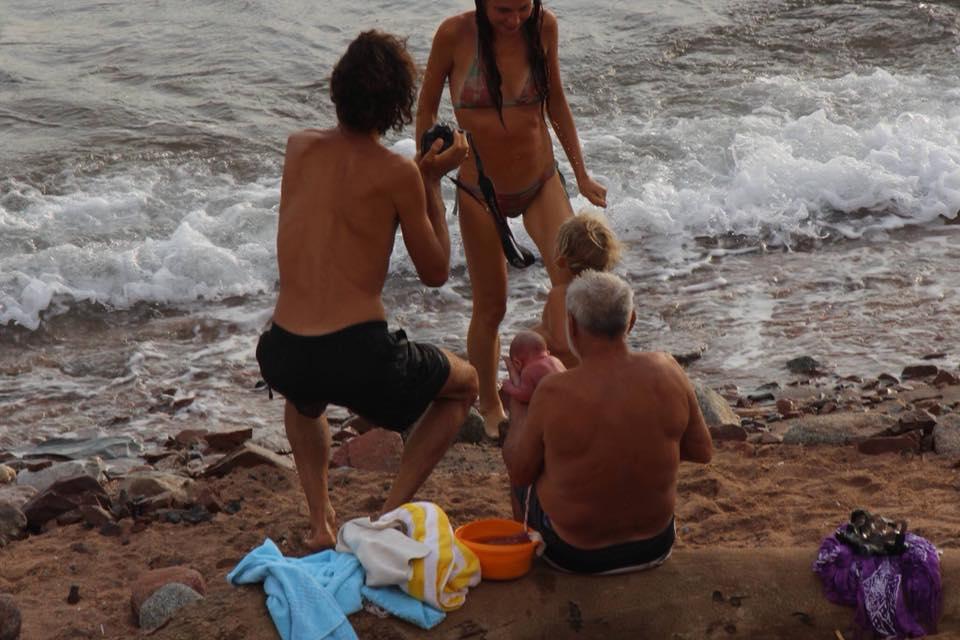 The mum emerges from the water to meet her newborn child 