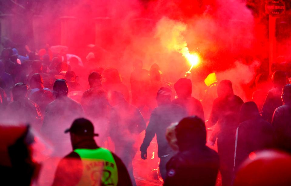  Marseille fans lit flares outside of the stadium before kick off