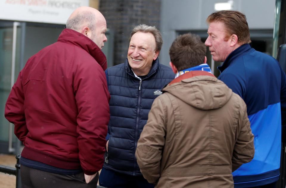  Neil Warnock chats to Cardiff fans who had already arrived at the stadium before the postponement