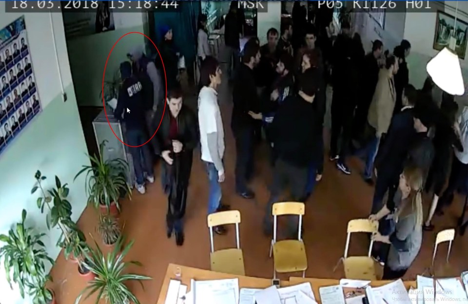 In this clip, voters can be seen creating a commotion at a polling station while a man, circled, pushes paper slips into a ballot box