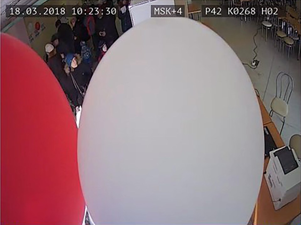 Officials appear to pull balloons over a CCTV camera in one clip