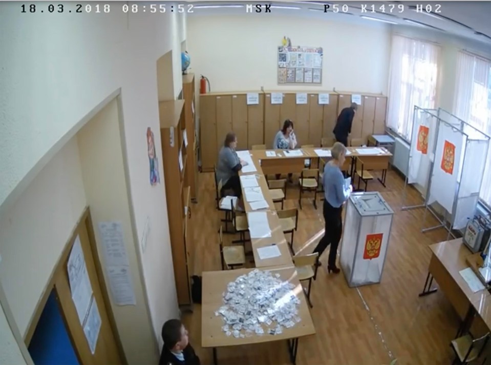 In one clip, a blonde official can be seen stashing voting slips in ballot boxes