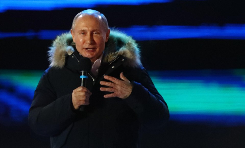 Putin is seen addressing a rally last night before the final results were announced 