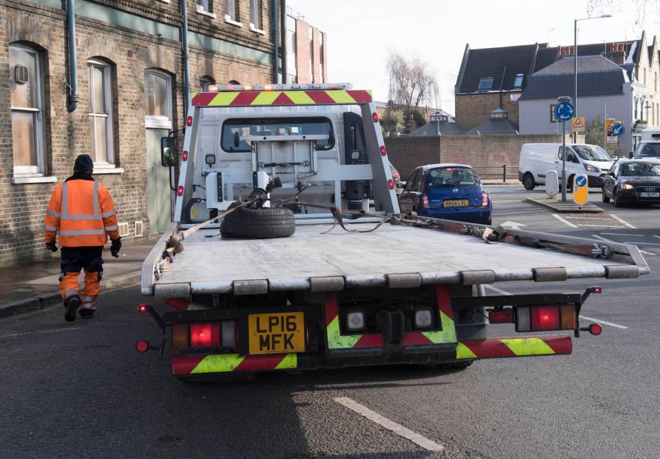 The remaining front wheel of Ant McPartlin's damaged mini is taken away by a recovery truck after yesterday's car crash 