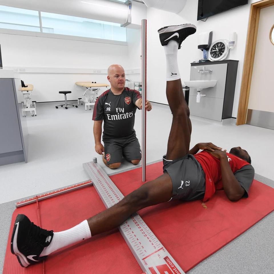  Arsenal No23 Danny Welbeck appears to have his flexibility measured