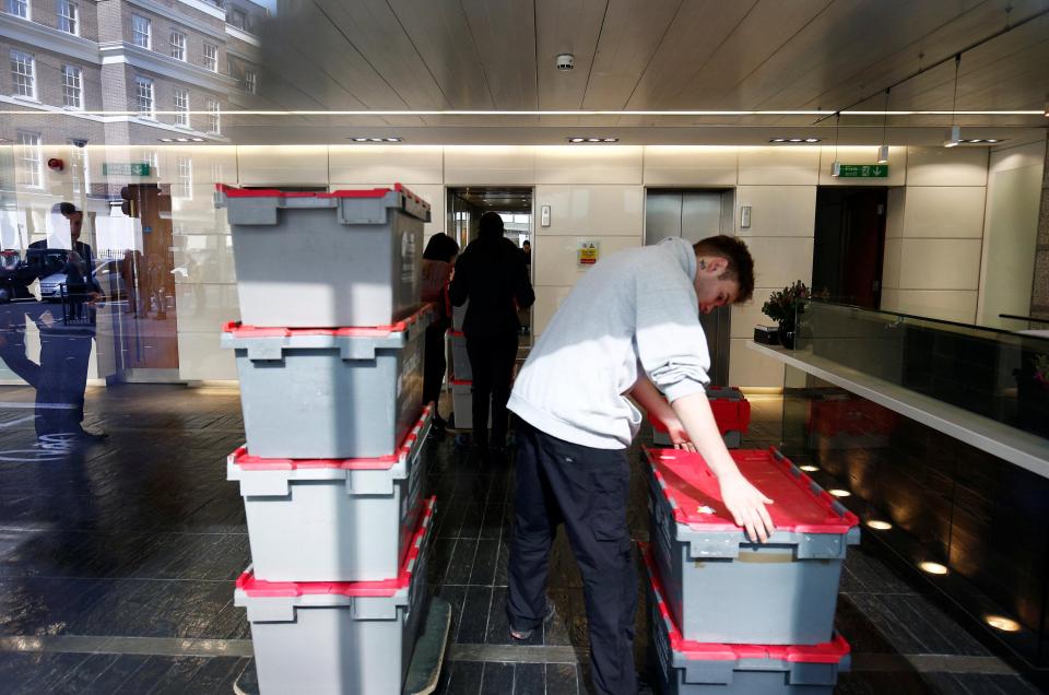  A man delivers crates to the building that houses the offices of Cambridge Analytica today