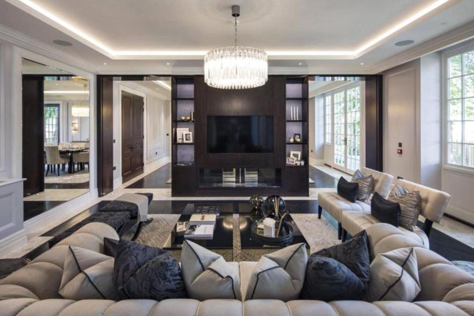  Pierre-Emerick Aubameyang's spacious living room has a gorgeous chandelier and huge TV in-built