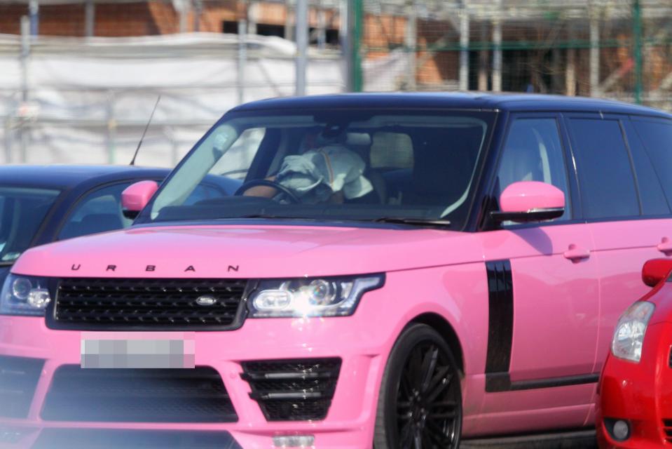  Earlier a woman, believed to be Katie, was snapped hiding behind clothing inside her pink Range Rover