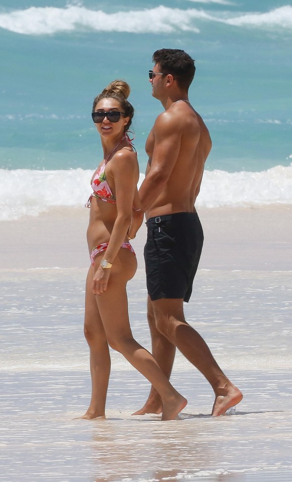 They held hands as they walked along the white sandy beaches with other holidaymakers