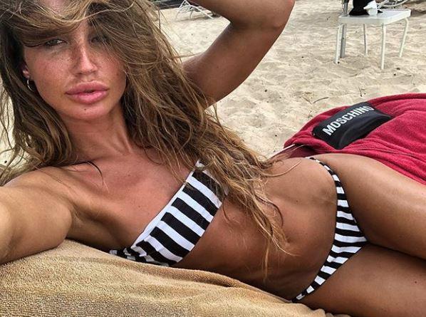  The former Towie star revealed her freckles and pout as she lounged on the beach