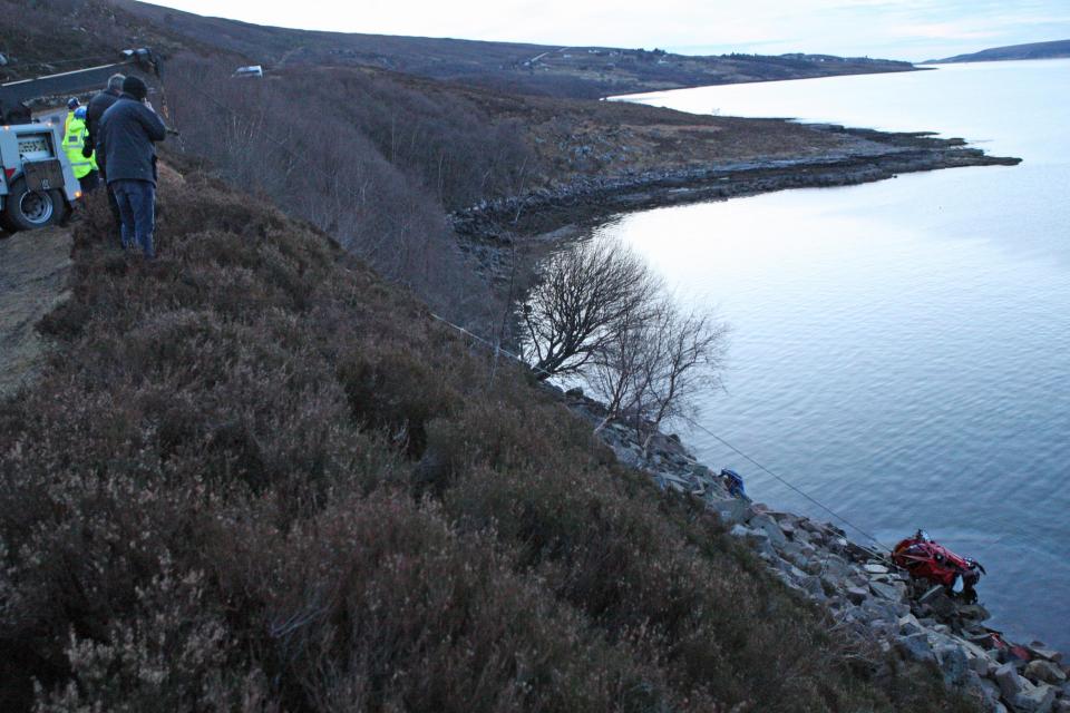  Rescue workers recover the car from the loch in the Highlands