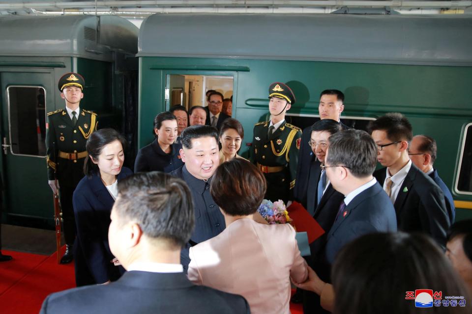  Kim and his wife Ri Sol-ju meet and greet Chinese officials after getting off the train