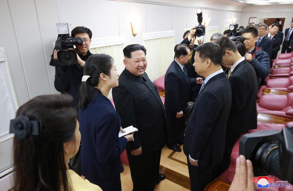  Kim Jong-un laughs with Chinese officials inside his bulletproof train