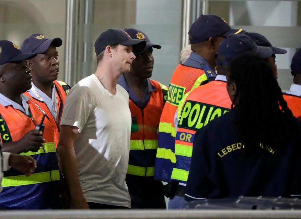  Police in Johannesburg take Steve Smith to the airport for his flight back to Australia